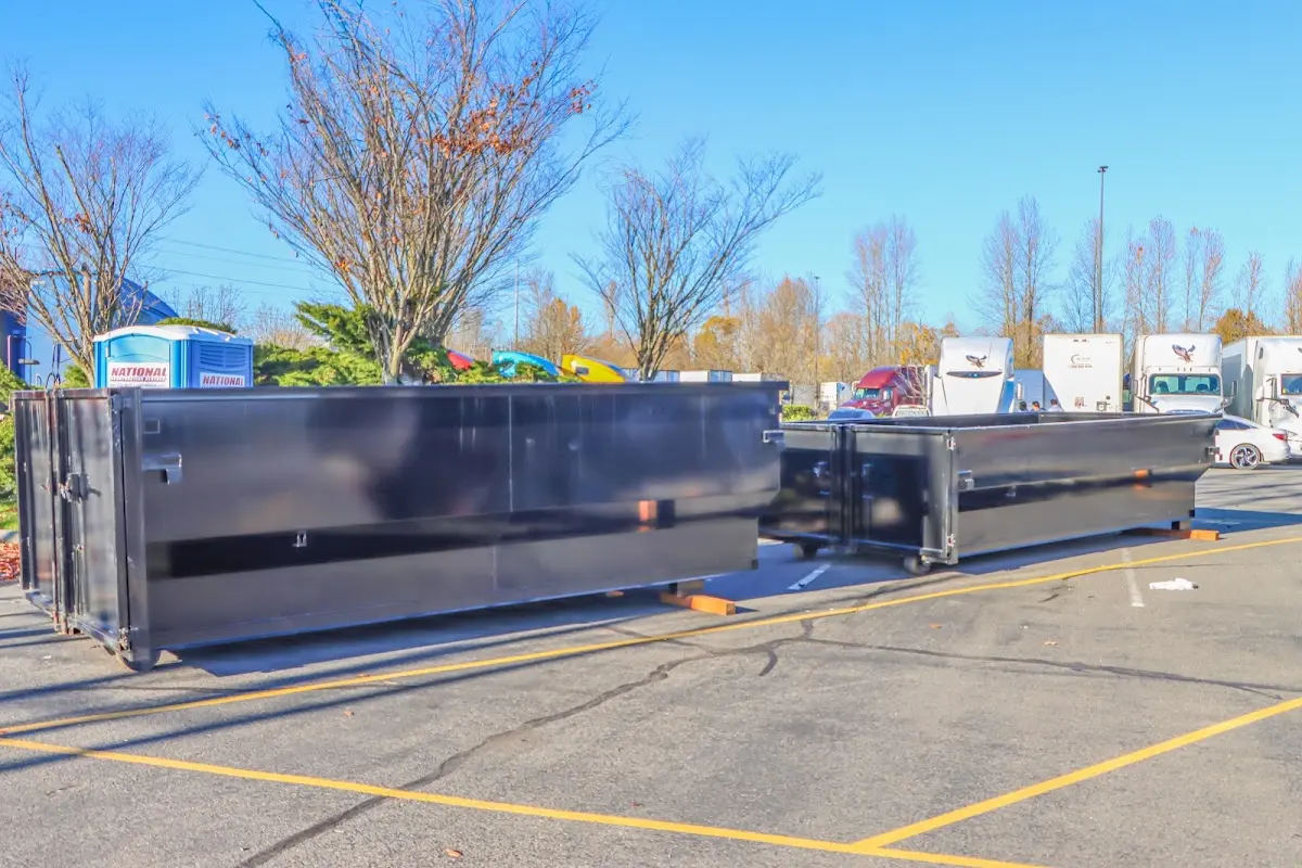 Professional dumpster rental service with roll-off container on residential driveway in Orangeburg
